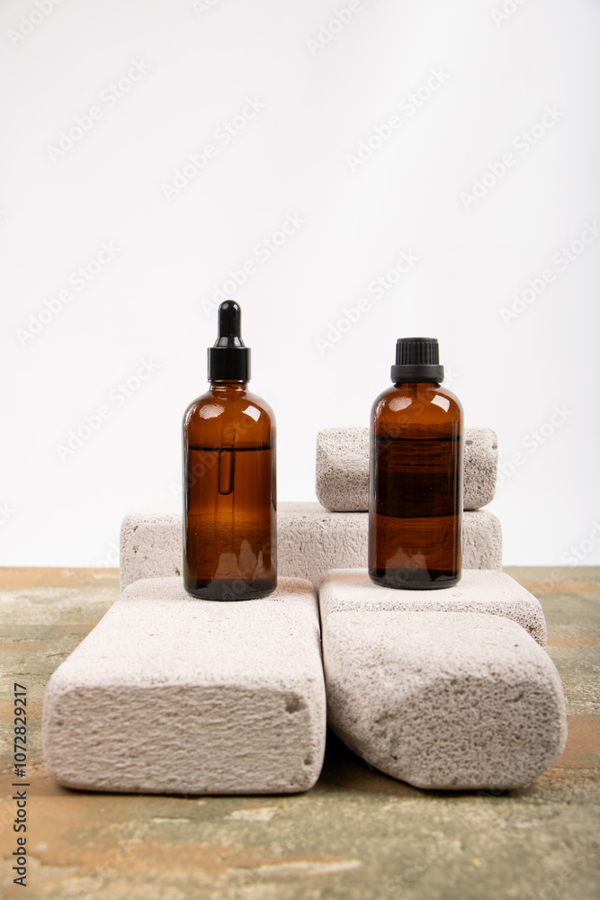 Amber Glass Bottles with Dropper and Screw Caps Displayed on Concrete Blocks Amber Glass Bottles with Dropper and Screw Caps Displayed on Concrete Blocks