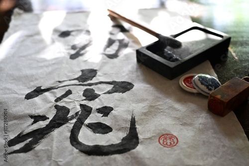 Chinrese calligraphy on rice paper with brush and name stamp and name stamp ink and inkwell