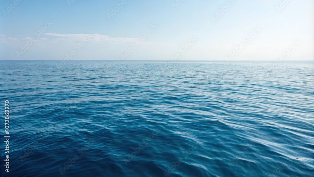 Calm sea surface with gentle ripples on blue ocean waters, vast expanse, reflective surface, soothing hue, oceanic backdrop Calm sea surface with gentle ripples on blue ocean waters, vast expanse, reflective surface, soothing hue, oceanic backdrop