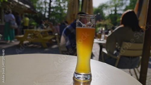 Enjoying pale ale and white wine on a sunny outdoor patio at a cafe