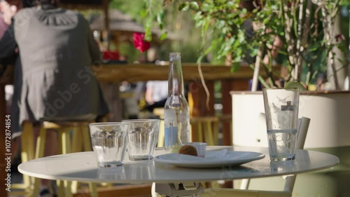 Outdoor restaurant table with uncleared dirty dishes and leftover food photo