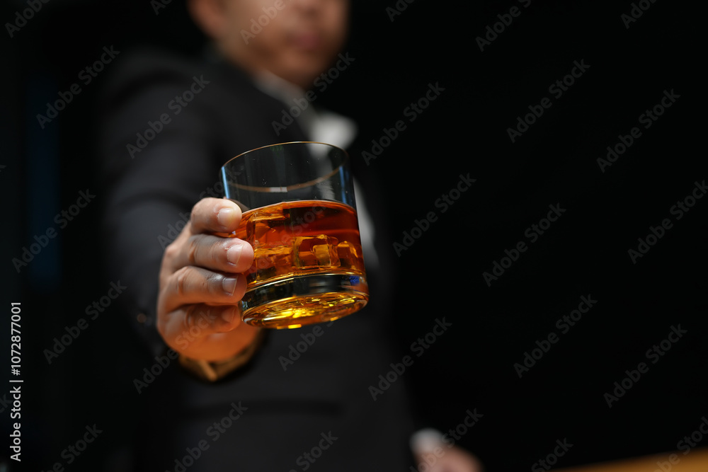 Closeup businessmen holding a glass of whiskey Closeup businessmen holding a glass of whiskey