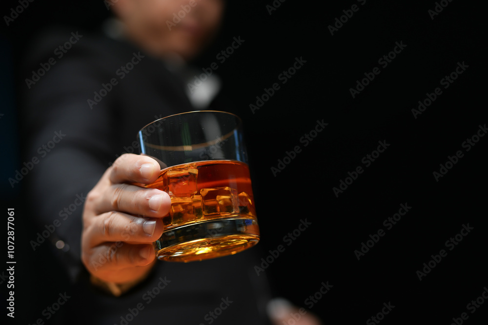Closeup businessmen holding a glass of whiskey Closeup businessmen holding a glass of whiskey