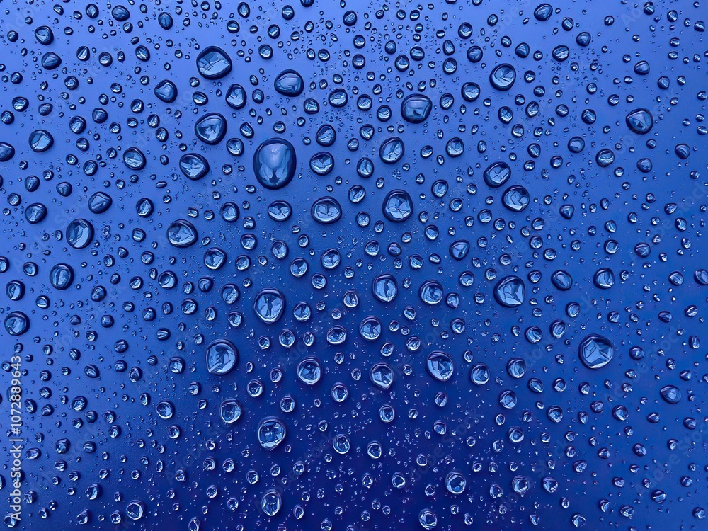 A cluster of small water drops on a dark blue metal sheet forms a visually appealing pattern with each drop radiating outward, metallic sheet, water spheres A cluster of small water drops on a dark blue metal sheet forms a visually appealing pattern with each drop radiating outward, metallic sheet, water spheres