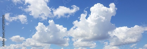 A stunning blue sky with cumulus clouds in various shapes and sizes floating gently, peaceful, serene