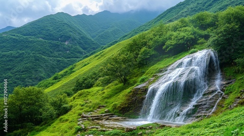 A dynamic waterfall rushing through the green valleys of the Wuling Mountains in China