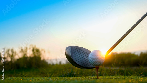 Golf clubs and balls on a green lawn in a beautiful golf course with morning sunshine. photo