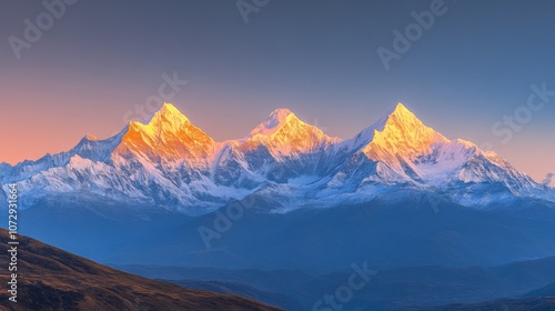 Snowy peaks of Meili Snow Mountain range (Kawagebo), Yunnan, China, at sunrise, with warm golden light illuminating the sharp, rugged, snow-capped peaks against a clear sky