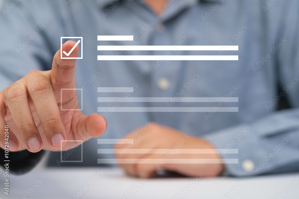 A person interacts with a digital checklist, indicating completion and organization in a modern work environment. A person interacts with a digital checklist, indicating completion and organization in a modern work environment.