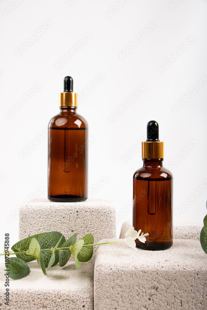 Amber Dropper Bottle on Textured Stone with Greenery for Natural Skincare and Wellness Amber Dropper Bottle on Textured Stone with Greenery for Natural Skincare and Wellness