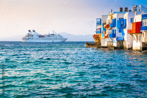 White architecture of Mykonos island, Greece. Cruise ship near the island.