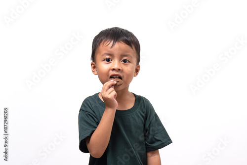 little boy hanging tasty cookies on white background