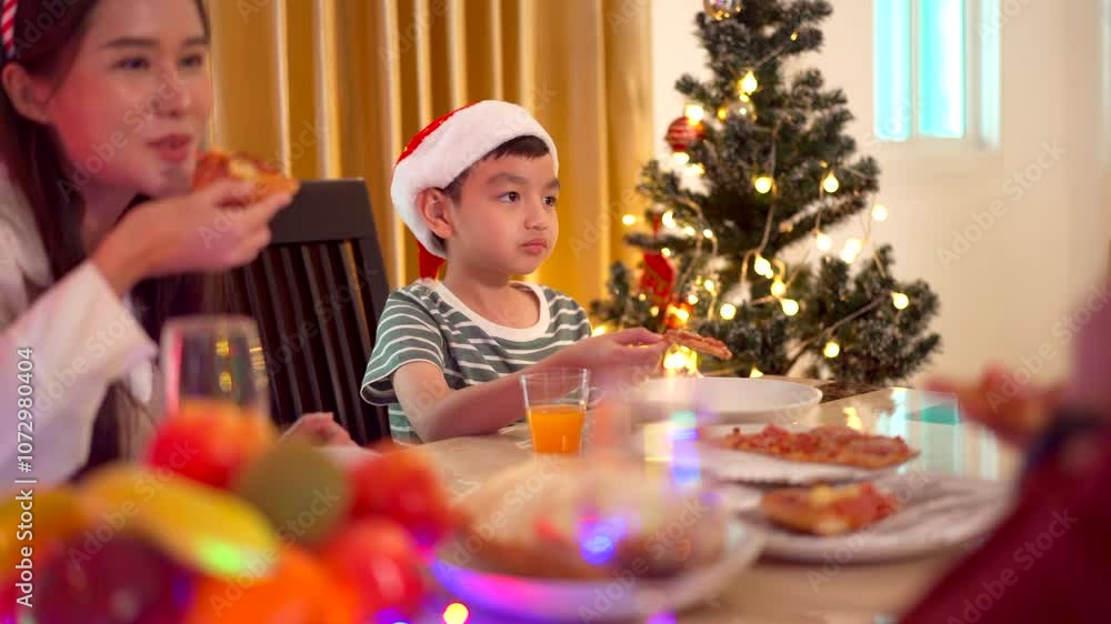Asian family is celebrating Christmas party together at home. Asian family is celebrating Christmas party together at home.