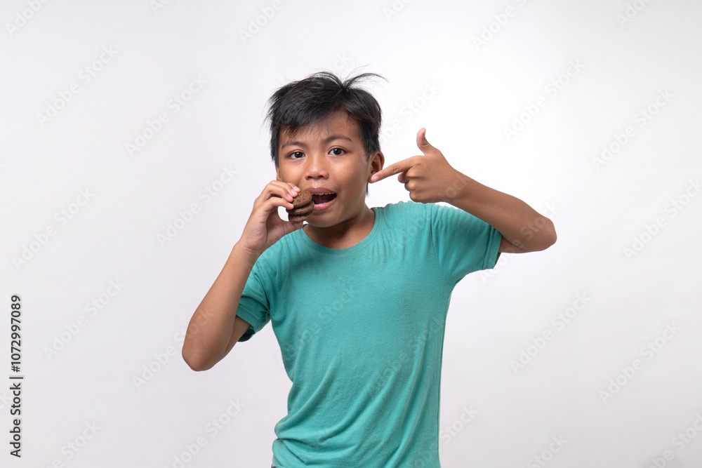 young boy hanging tasty cookies on white background young boy hanging tasty cookies on white background