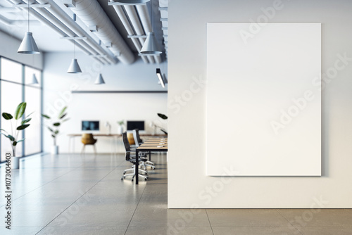 Modern office interior with blank vertical poster on wall, coworking desks and chairs by large windows, clean and minimal style. 3D Rendering photo