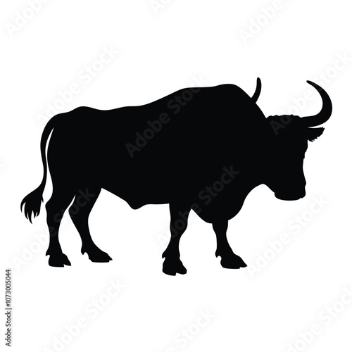 a angry bull. The bull is standing on all fours and is facing towards silhouette