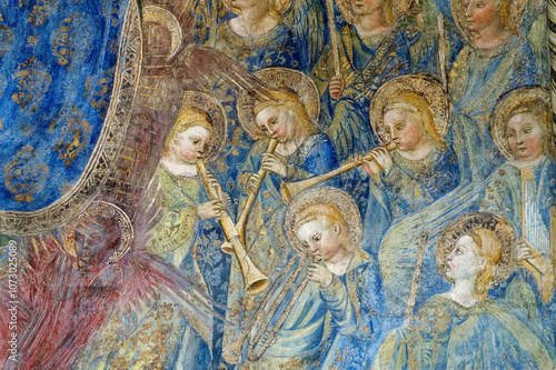 Fresco (15th century) of a group of musician angels in the sky playing music. ...