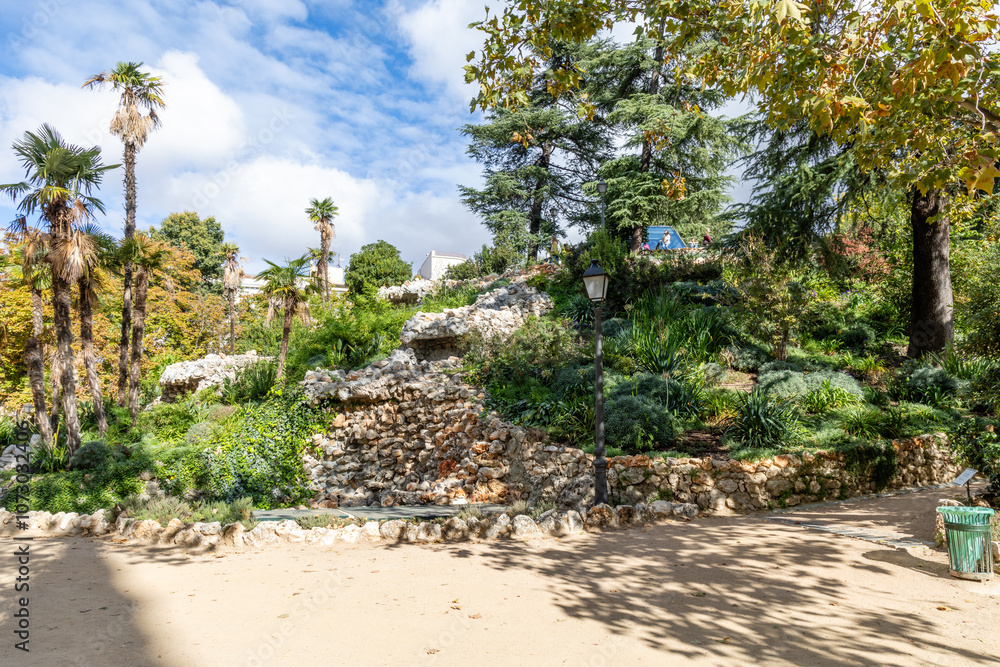 Madrid, Spain - october 10, 2024: Retiro Park with trees dyed by the colors of autumn in Madrid, Spain Madrid, Spain - october 10, 2024: Retiro Park with trees dyed by the colors of autumn in Madrid, Spain
