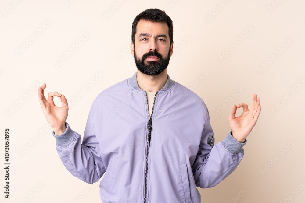 Caucasian man with beard wearing a jacket over isolated background in zen pose Caucasian man with beard wearing a jacket over isolated background in zen pose