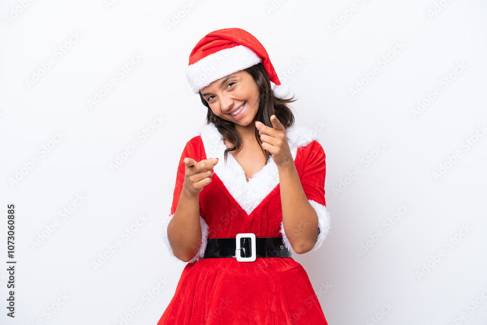 Young hispanic woman dressed as mama noel isolated on white background points finger at you while smiling Young hispanic woman dressed as mama noel isolated on white background points finger at you while smiling