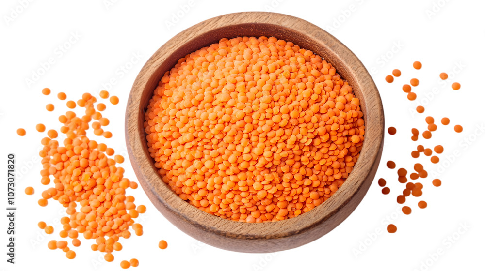 Red Lentils in Wooden Bowl: A top view of a rustic wooden bowl filled with red lentils, with some lentils scattered around the bowl. Red Lentils in Wooden Bowl: A top view of a rustic wooden bowl filled with red lentils, with some lentils scattered around the bowl.