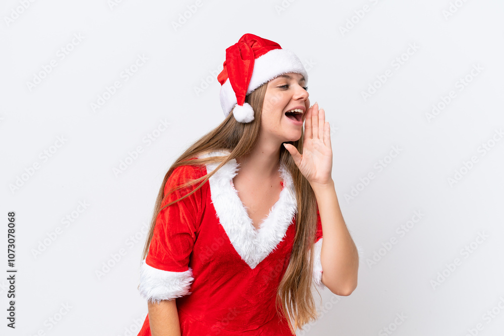 Young caucasian woman dressed as mama noel isolated on white background shouting with mouth wide open to the lateral Young caucasian woman dressed as mama noel isolated on white background shouting with mouth wide open to the lateral