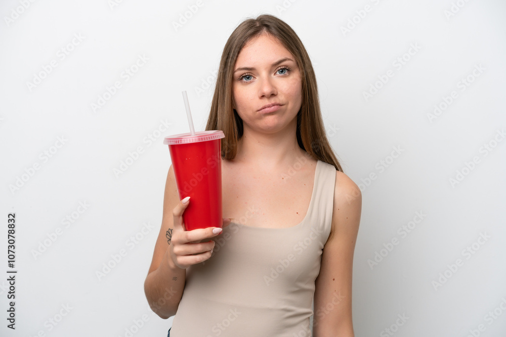 Young Lithuanian woman holding refreshment isolated on white background with sad expression Young Lithuanian woman holding refreshment isolated on white background with sad expression