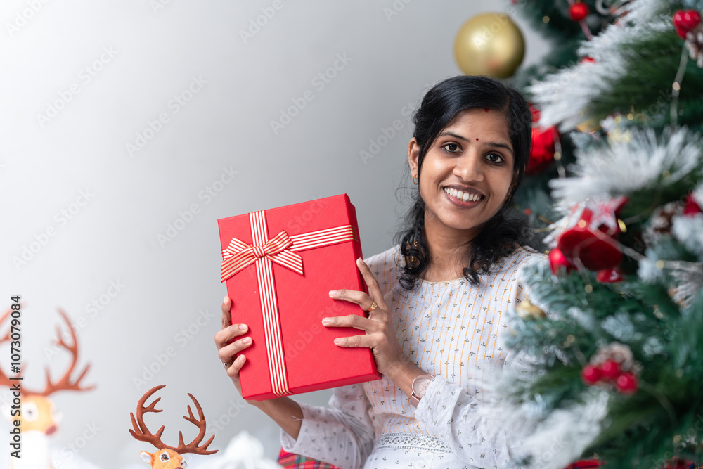 A beautiful young Indian girl holding chrismas gift boxes, smiling young girl celebrating merry Christmas 2024, chrismas shopping and offer sale concept. 2024 happy Christmas photography.
A beautiful young Indian girl holding chrismas gift boxes, smiling young girl celebrating merry Christmas 2024, chrismas shopping and offer sale concept. 2024 happy Christmas photography.