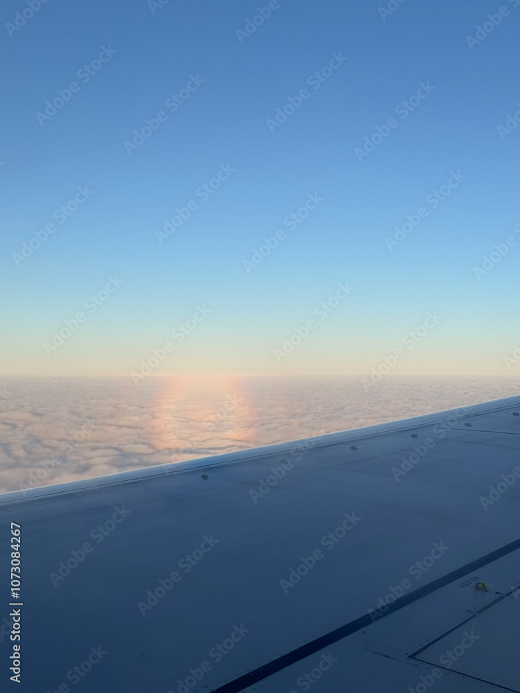 Halo rainbow full circle in the sky from a plane view over the clouds, blue sky Halo rainbow full circle in the sky from a plane view over the clouds, blue sky