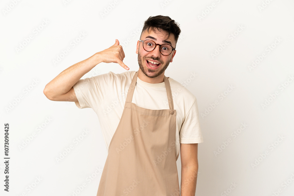 Restaurant waiter caucasian man isolated on white background making phone gesture. Call me back sign Restaurant waiter caucasian man isolated on white background making phone gesture. Call me back sign