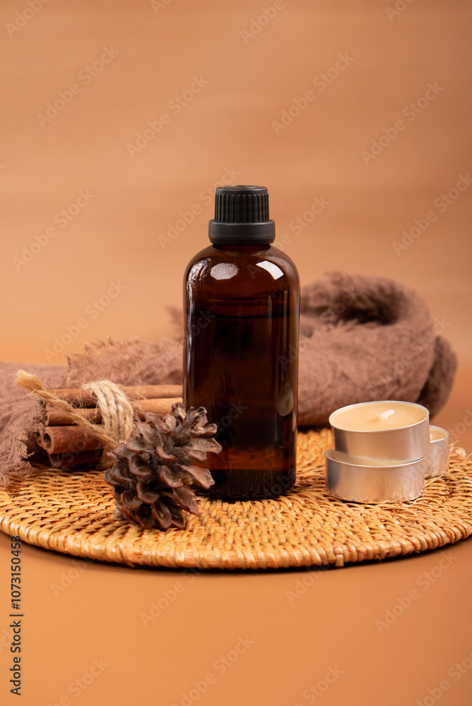 Amber Glass Essential Oil Bottle with Candles and Diffuser on Woven Mat for Spa and Relaxation Amber Glass Essential Oil Bottle with Candles and Diffuser on Woven Mat for Spa and Relaxation