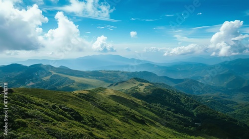 A breathtaking mountain landscape under a blue sky with fluffy clouds.