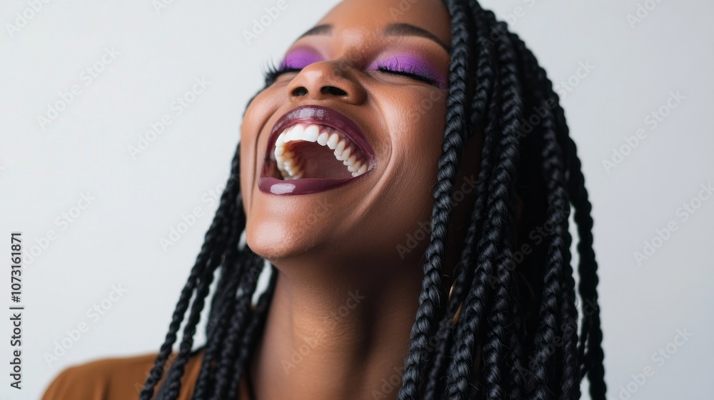 A woman with long dreadlocks is smiling and laughing A woman with long dreadlocks is smiling and laughing