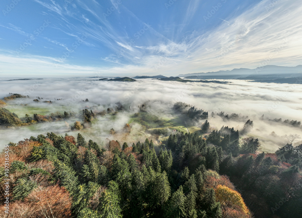 Aerial landscape photo with low level clouds on a fall morning in the border area between Germany and Austria with the Bregenz Forest Mountains, Vorarlberg, Austria , Bavaria, Germany Aerial landscape photo with low level clouds on a fall morning in the border area between Germany and Austria with the Bregenz Forest Mountains, Vorarlberg, Austria , Bavaria, Germany