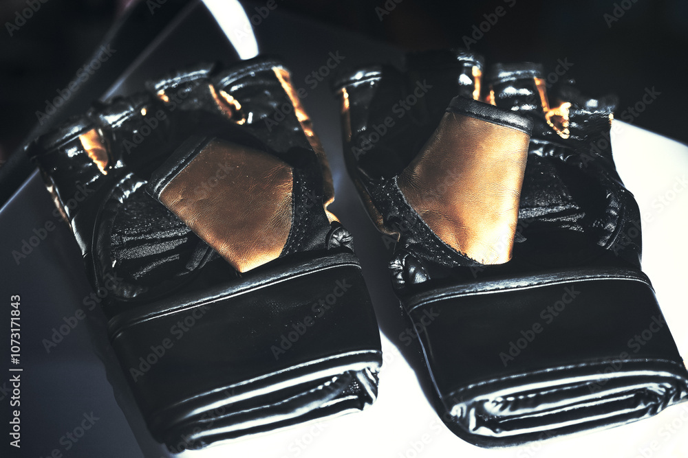 Training boxing gloves. Black and gold boxing gloves placed on a table