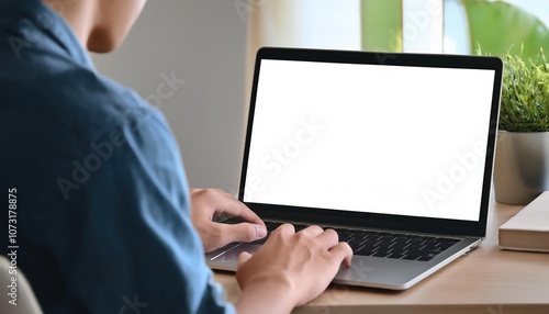 Over-The-Shoulder Shot of a Young Man Using Computer with Blank White Screen