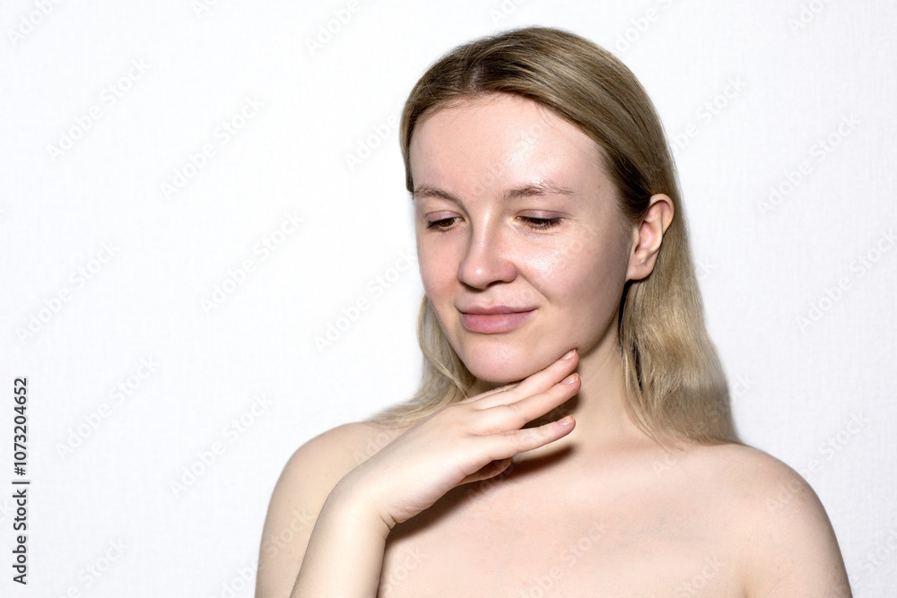 Portrait of a fair girl, without makeup and bare shoulders on a white background. Portrait of a fair girl, without makeup and bare shoulders on a white background.