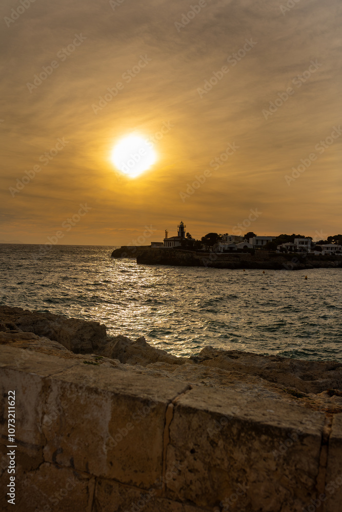 Sunset over the sea and cliff at Cala Blanca, Menorca, Spain Sunset over the sea and cliff at Cala Blanca, Menorca, Spain