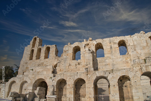 Ancient ruins of the Odeon of Herodes Atticus under a clear blue sky in Athens, showcasing its historic architecture and stone craftsmanship photo