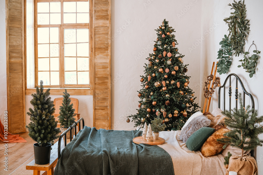 Cozy bedroom adorned with a Christmas tree and festive decorations during winter Cozy bedroom adorned with a Christmas tree and festive decorations during winter