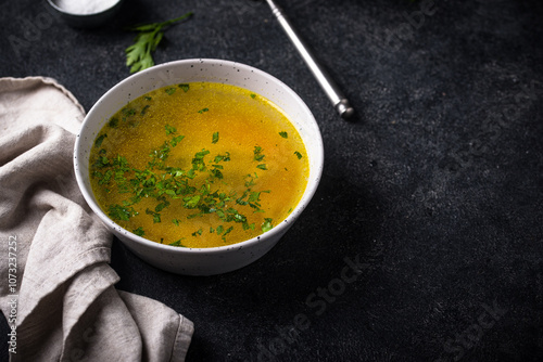 Chicken broth with parsley, healthy food photo