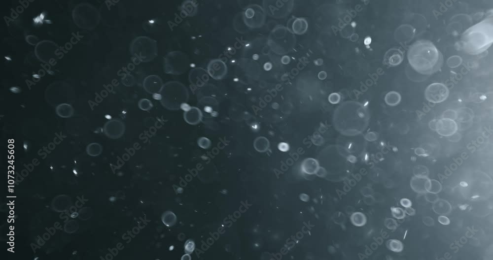 Floating abstract particle bokeh on dark background Floating abstract particle bokeh on dark background