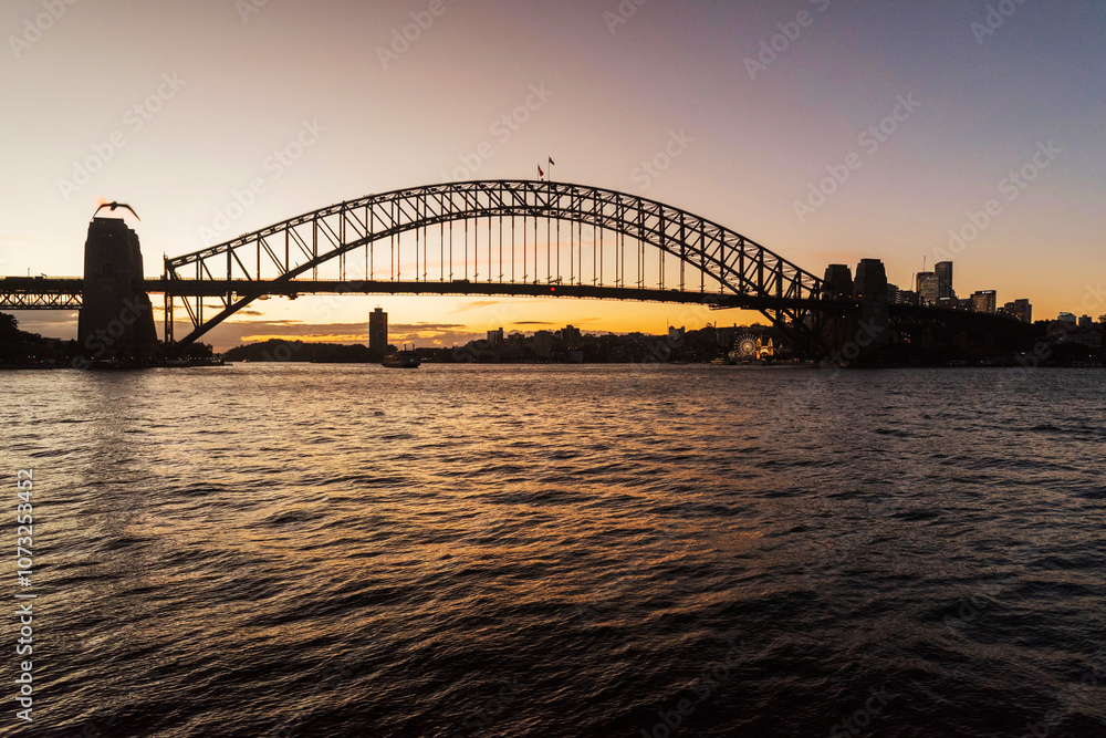Picturesque view on Sydney Harbor Bridge at sunset. The bridge was opened in 1932 and it is the tallest steel arch bridge in the world. Picturesque view on Sydney Harbor Bridge at sunset. The bridge was opened in 1932 and it is the tallest steel arch bridge in the world.