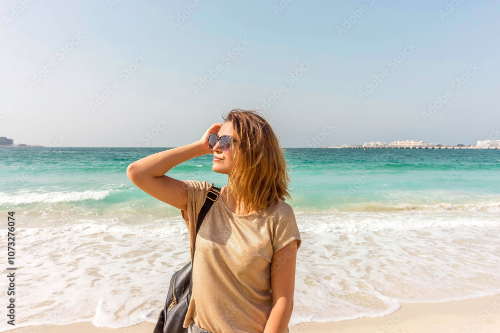 Young Woman Enjoying Sunny Weather On The Jumeirah Beach, Dubai, United Arab Emirates Young Woman Enjoying Sunny Weather On The Jumeirah Beach, Dubai, United Arab Emirates