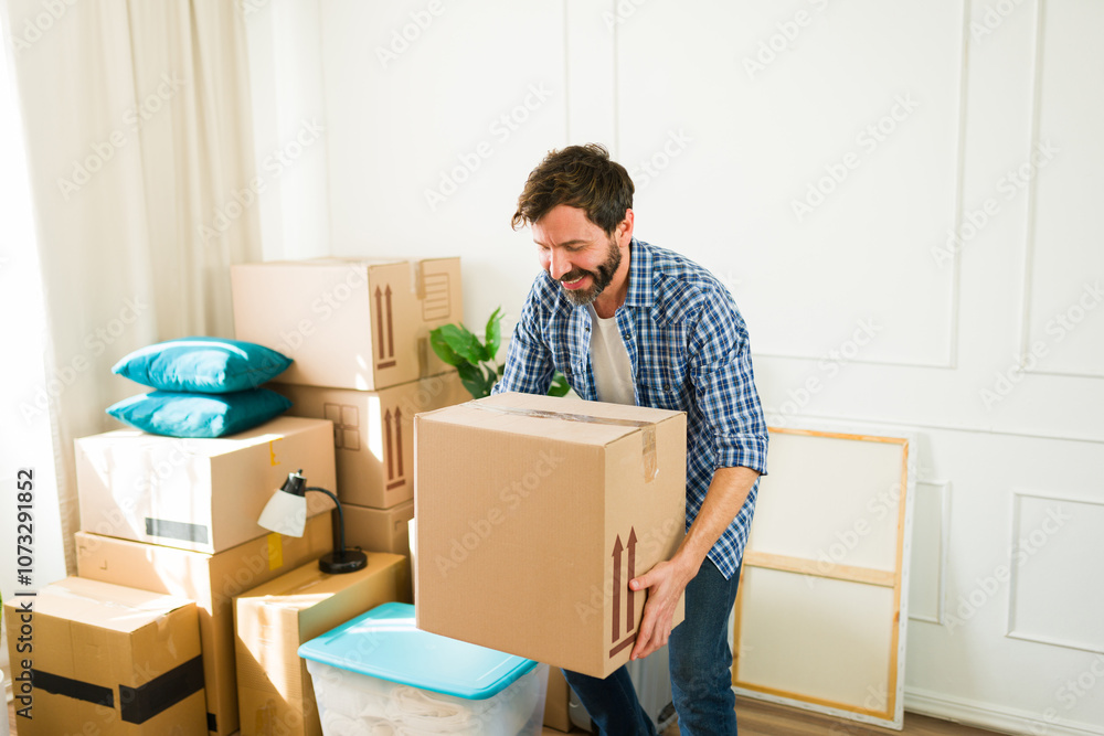 Happy man eagerly settles into his new apartment, unwrapping his cardboard box of belongings with excitement as he makes his new home Happy man eagerly settles into his new apartment, unwrapping his cardboard box of belongings with excitement as he makes his new home