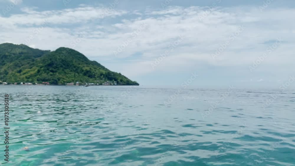 Tranquil Tropical Seascape. A serene view of a tropical island with clear turquoise water and lush green hills in the background. Tranquil Tropical Seascape. A serene view of a tropical island with clear turquoise water and lush green hills in the background.