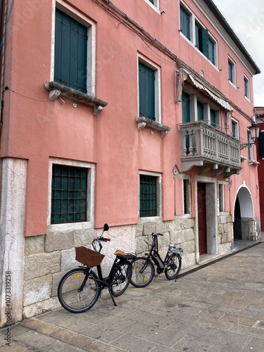 Urban Italy, bicycles in front of multi colored town houses on waterfront, Chioggia