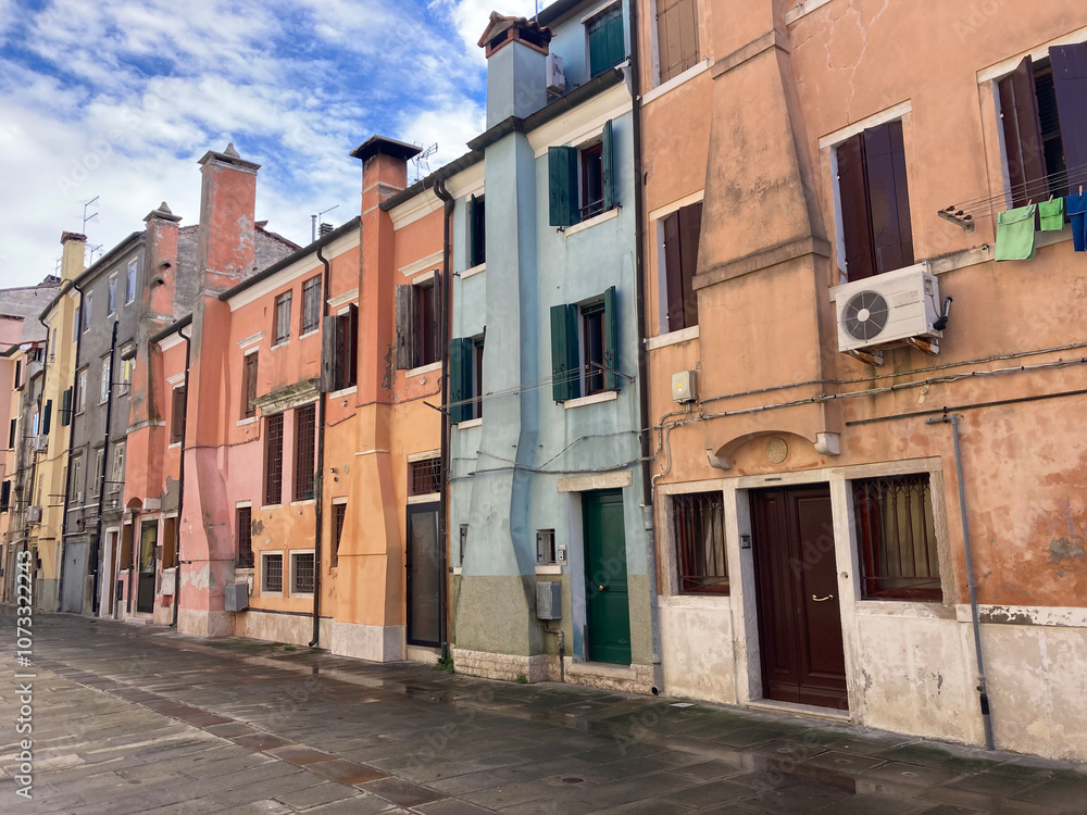 View along street in Chioggia, Italy with colorful houses View along street in Chioggia, Italy with colorful houses