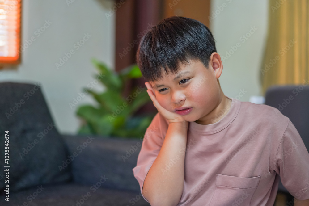 Young child experiencing toothache, embodying childhood dental pain. The child facial expression, hand gently pressed against the cheek, dental care, children's oral health, pediatric dental check-up Young child experiencing toothache, embodying childhood dental pain. The child facial expression, hand gently pressed against the cheek, dental care, children's oral health, pediatric dental check-up