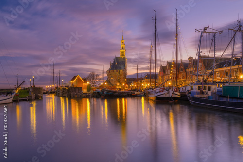 Hoorn, Netherlands. An ancient harbor and marina. Old sailing ships. View of houses during evening. A cityscape in the evening. Postcard, background, wallpaper.